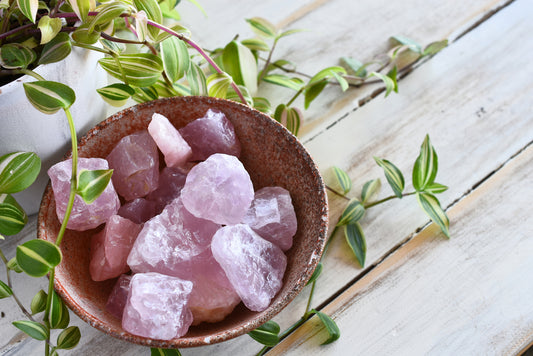 Collection of Rose Quartz gemstones in a bowl.